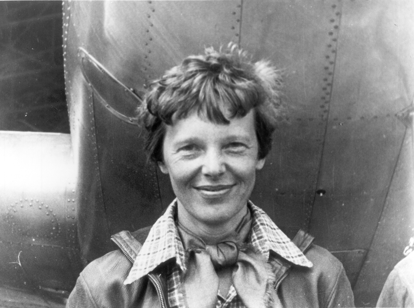 Amelia Earhart standing beside the nose of her Lockheed Electra 10E, 1937