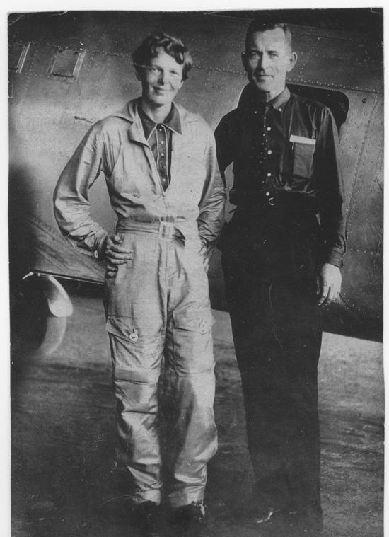 Amelia Earhart and navigator Fred Noonan standing beside the Lockheed Electra 10E during the 1937 world flight