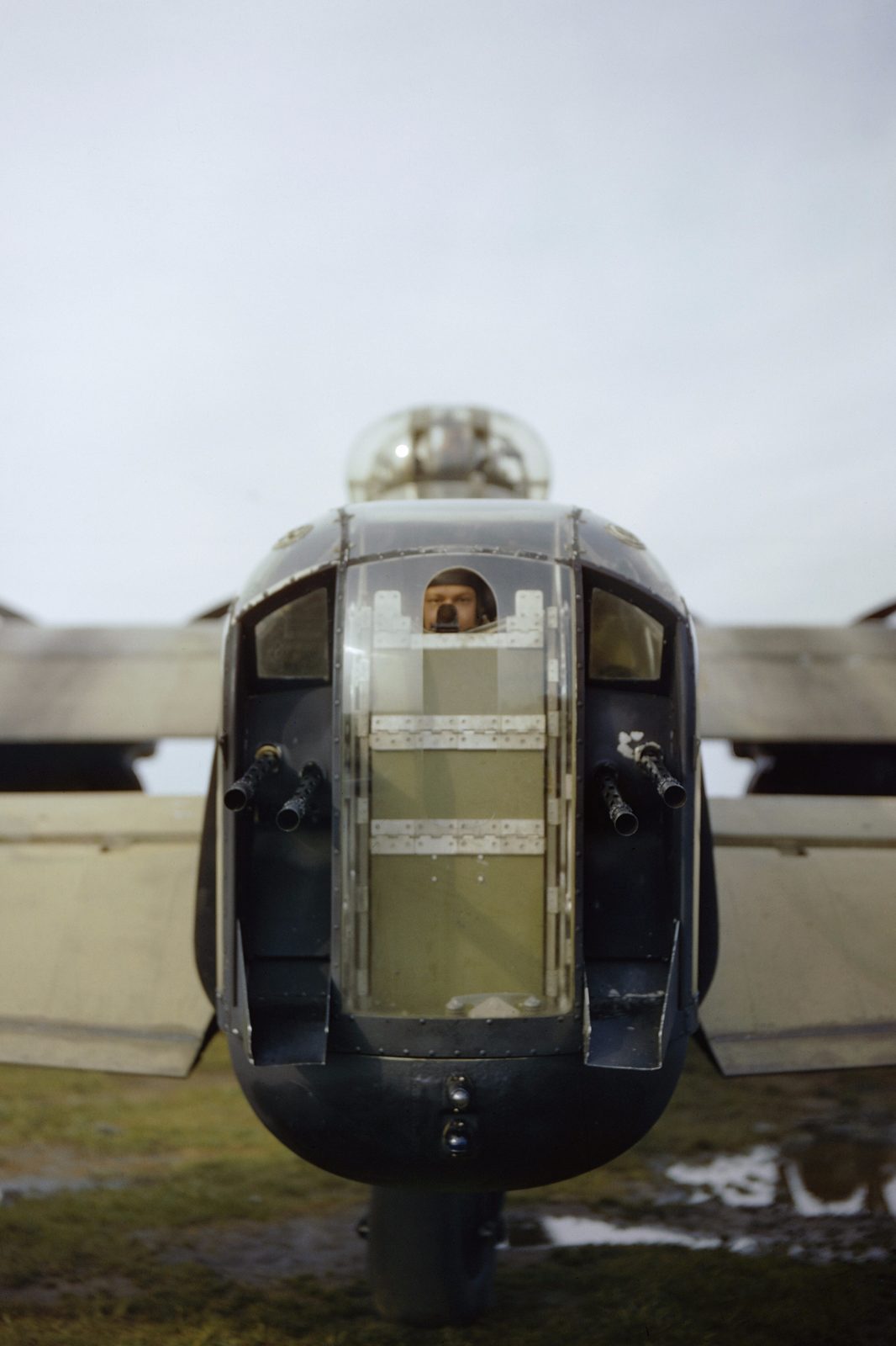RAF rear gunner of a Lancaster looking out through his perspex tail turret, October 1942