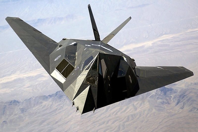 F-117 Nighthawk stealth fighter banking in flight, showing its full angular airframe