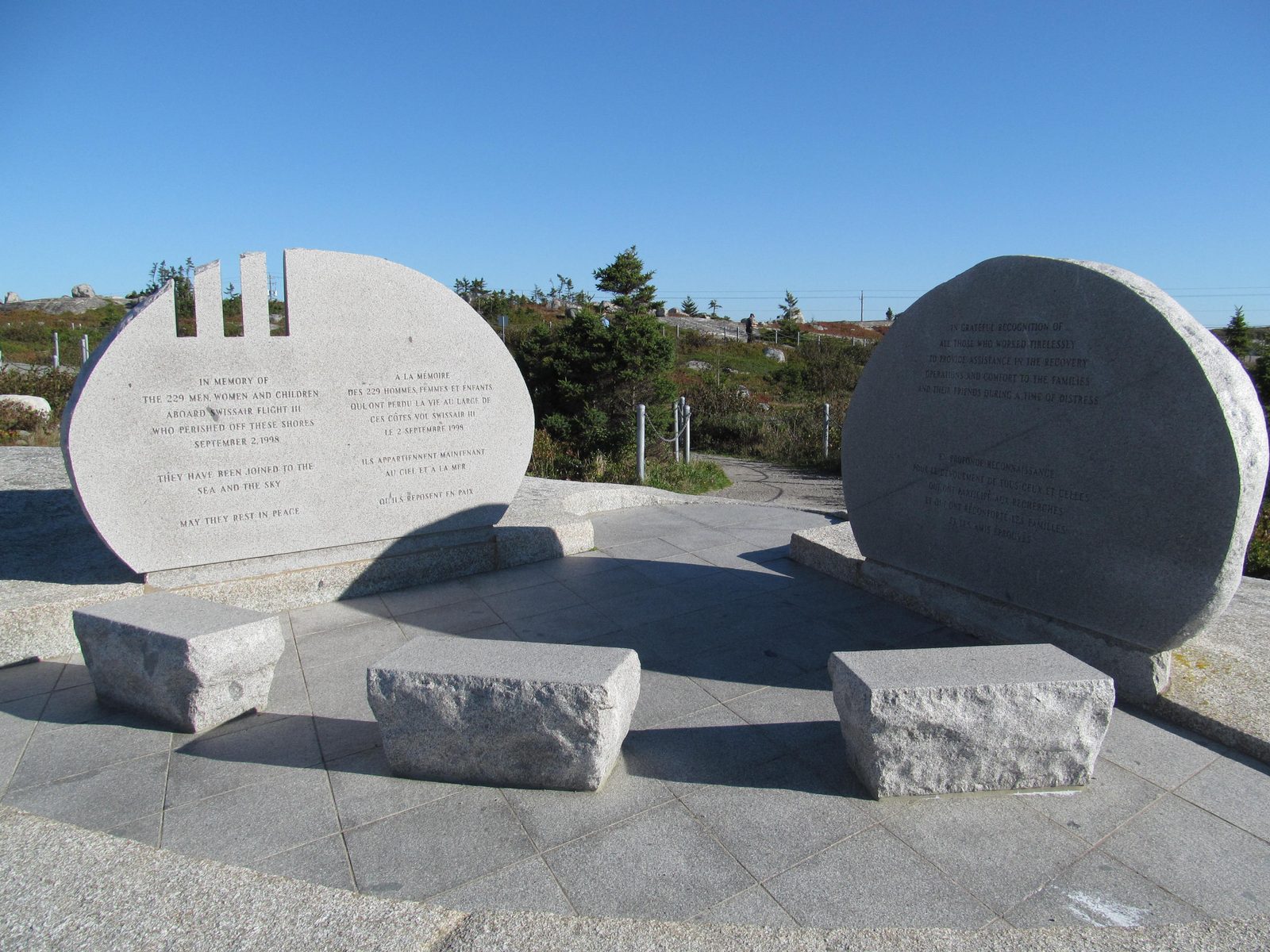 The Swissair Flight 111 memorial at The Whalesback near Peggys Cove, Nova Scotia: two curved granite monuments facing each other across a stone plaza