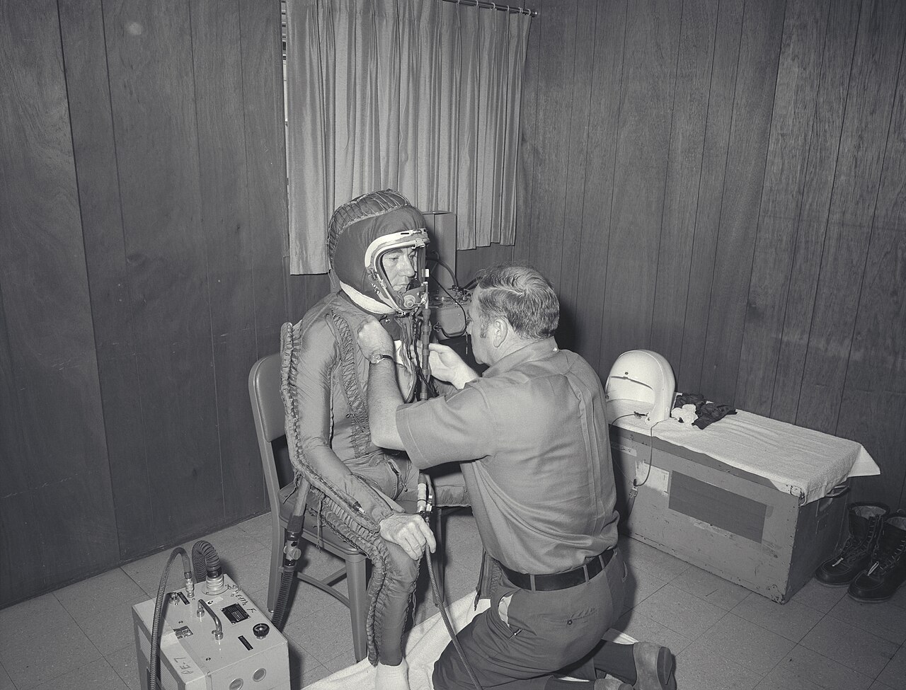 A U-2 pilot being fitted into a full-pressure flight suit inside a flight support trailer, NASA Ames Research Center, July 1971